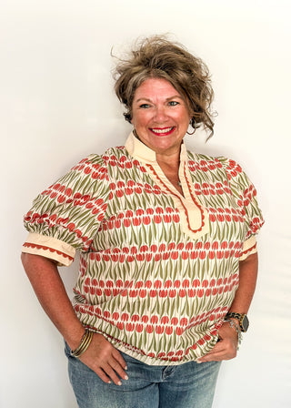 Large puff sleeve top with terracotta tulips and green leaves.  Contrast is ecru with terracotta scallop detail-short sleeve and v-neck.