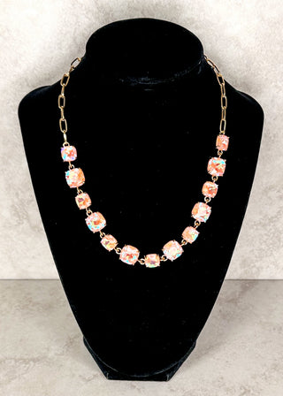 Peach gemstone necklace displayed in a black neck form