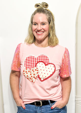 Sequin short sleeve top with 3 heart appliques.