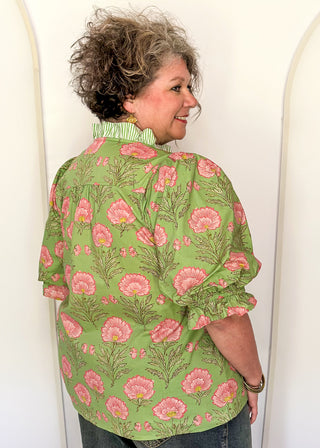 matcha green floral puff sleeve blouse with pink oversized floral print and striped contrast trim along the neckline and front placket.