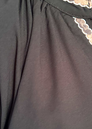 Solid black lightweight dress with v-neck and 3/4 length sleeve. Leopard lace detail on the sleeves, collar and v-neck.