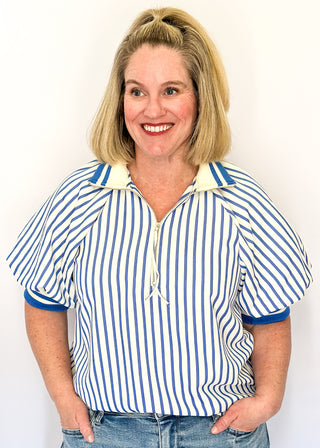 Women’s blue striped short sleeve 1/4 zip top with lightweight fabric, stripe elastic sleeve and collar detail.