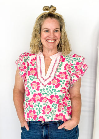 pink floral with large double ruffle short sleeve top - ruffles trimmed in pink and white striped contrast also runs along v neck- ruffle color - green stems