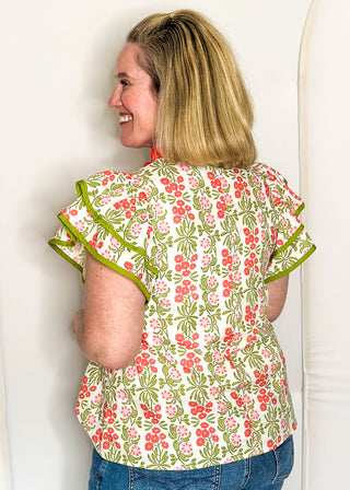 Floral print top with decorative neckline and short ruffle sleeves