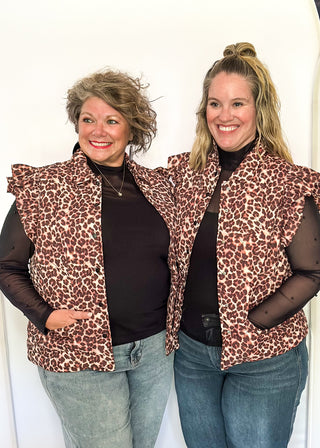 Leopard print Puffer vest with black button closures.  2 front pockets and ruffle detail on the sleeve. 