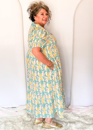 Floral midi dress with contrast neckline, short puff sleeves, and tiered skirt