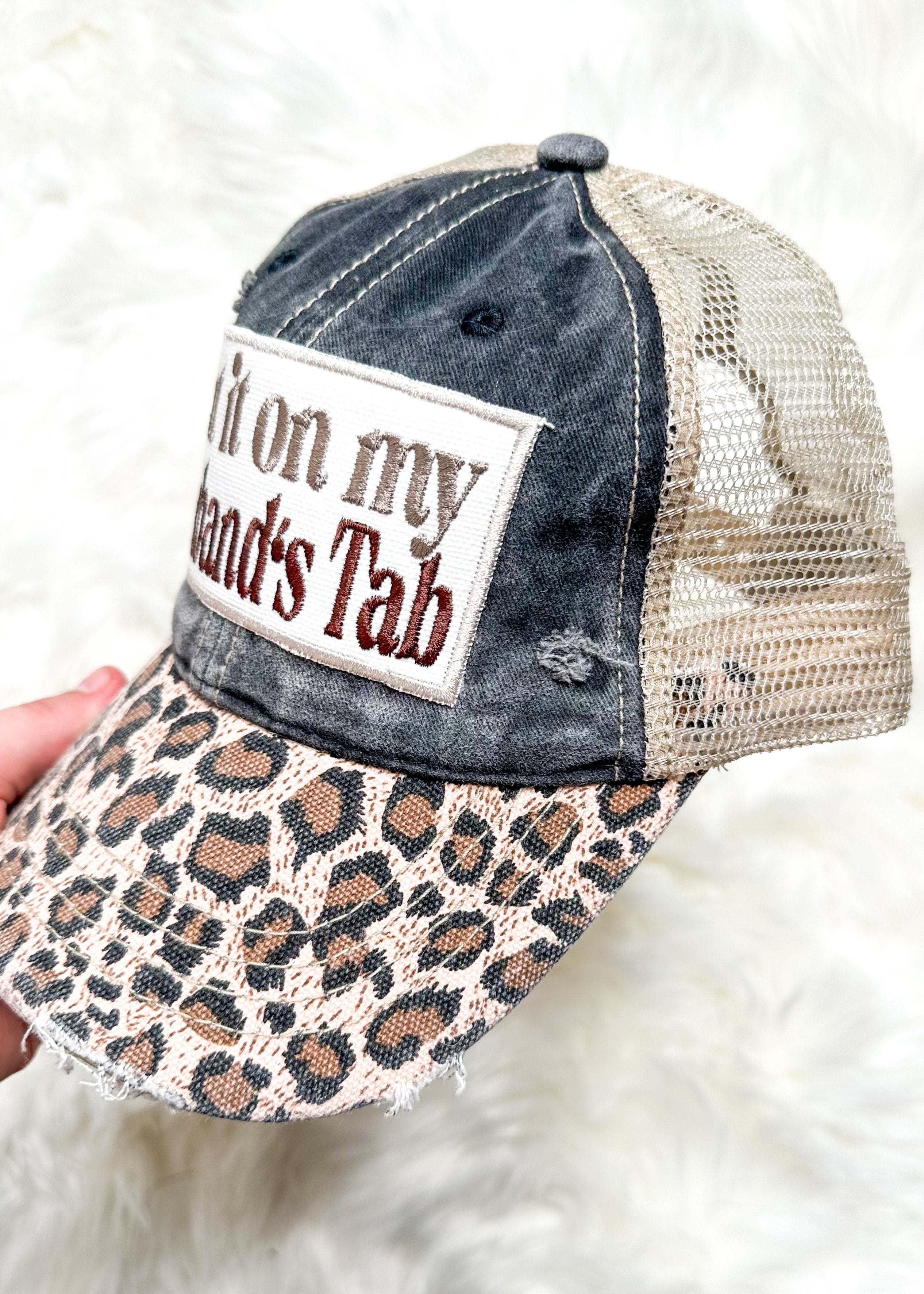 leopard bill snap back trucker hat - front is a charcoal gray and back is a khaki net - neutral put it on my husband's tab embroidered patch on the front