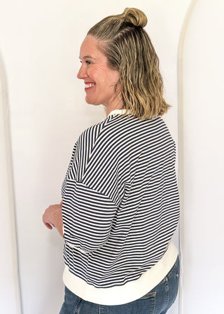 Striped knit dolman top with crew neckline and ribbed trim in navy.