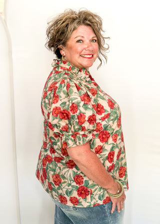 Light Pink short sleeve top, v-neck with ruffle detail.  Elastic detail on the sleeve.  Large Rose pattern with jade leaves. 