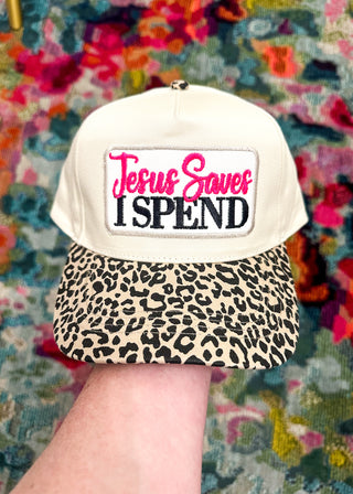 Ivory hat with leopard bill and “Jesus Saves I SPEND” embroidered patch in hot pink and black stitching. 