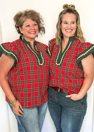 Red plaid flutter sleeve top- with dark green contrast and off white scallop detail.