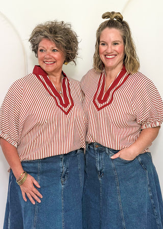 Models wearing a brick and cream striped dolman-sleeve top with contrast trim, styled for a casual and relaxed fit.
