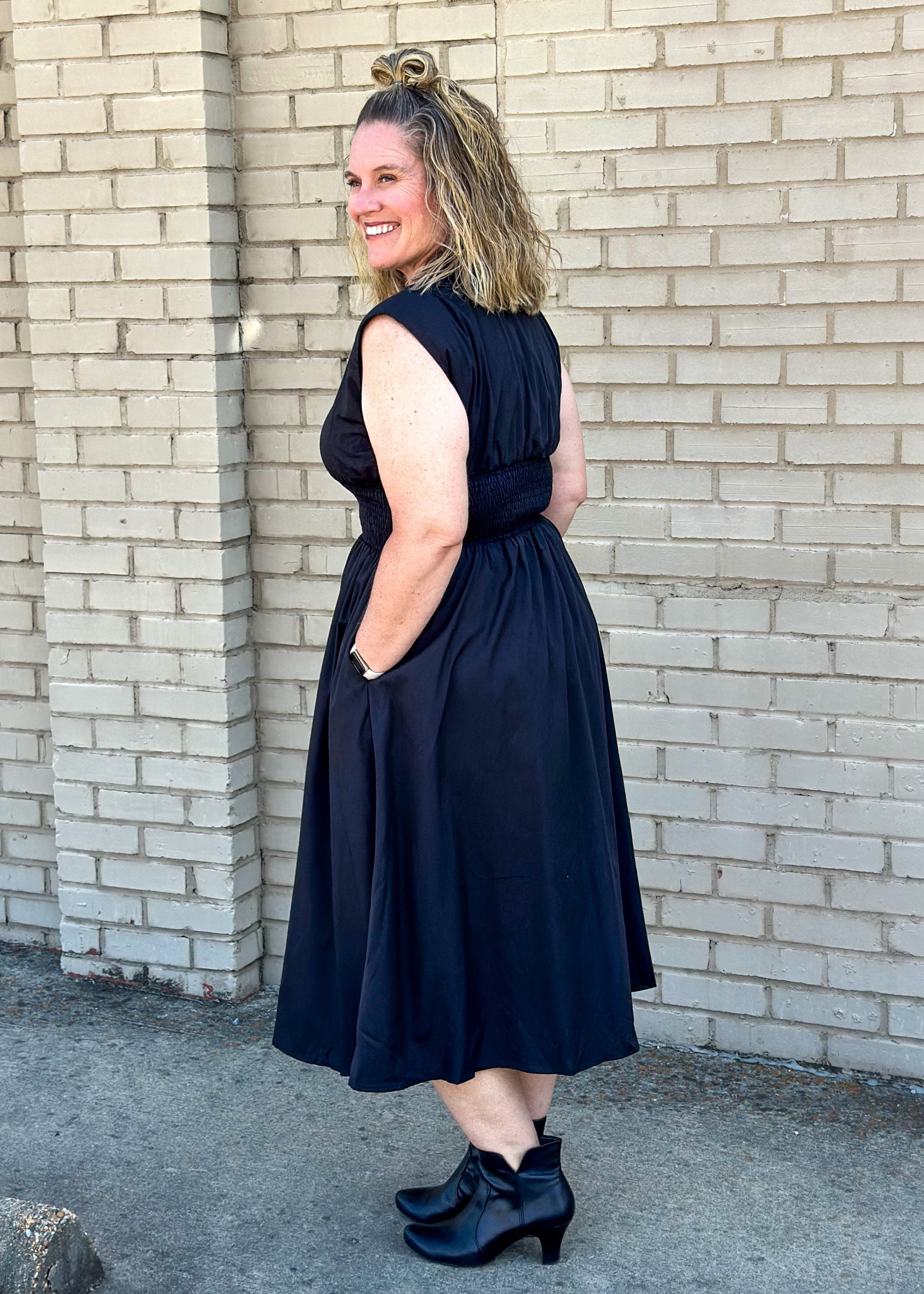 entro brand black midi dress with gold zipper down the front, smocked waistband, lined and pockets