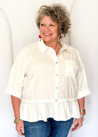 White button-up top with ruffle hem, short sleeves