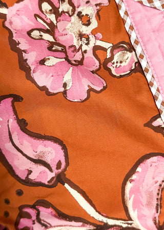 close up of rust, pink and off white floral top fabric