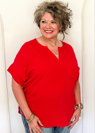 Solid textured blouse with a V-notch neckline, short sleeves