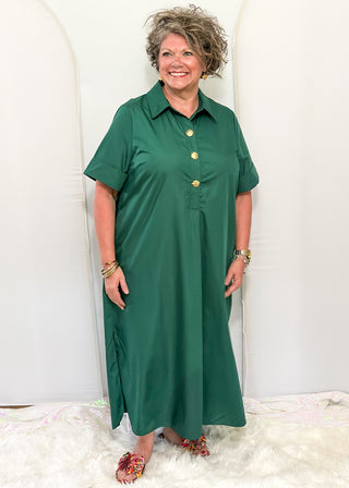 Woman wearing short sleeve, collared, Hunter Green midi dress with decorative gold snaps.