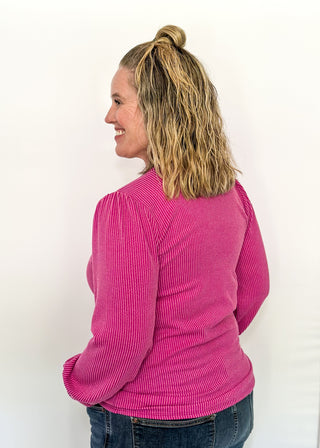long sleeve ribbed top with cuff sleeve and small puff detail in shoulder. crew neck. 