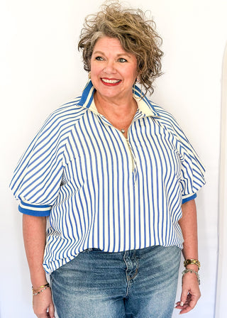 Women’s blue striped short sleeve 1/4 zip top with lightweight fabric, stripe elastic sleeve and collar detail.