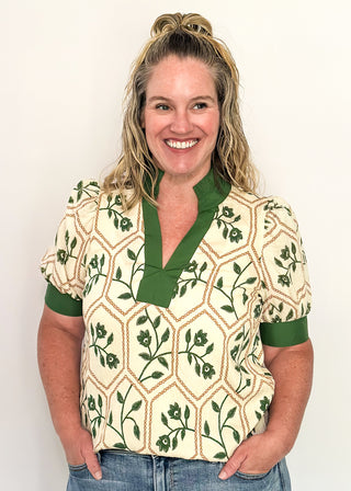 Neutral blouse featuring green florals with geometric hexagon pattern