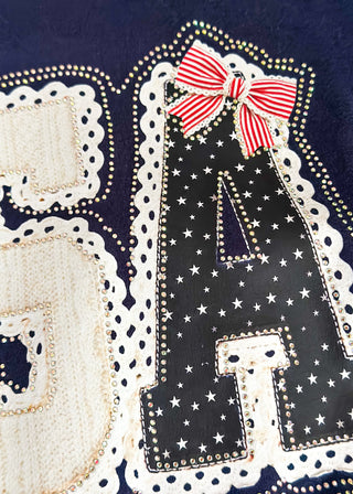 close up of navy short sleeve tee with USA graphic an rhinestone detail.