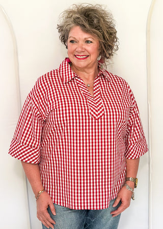 Gingham blouse with split neckline, collar, and 3/4 sleeves.
