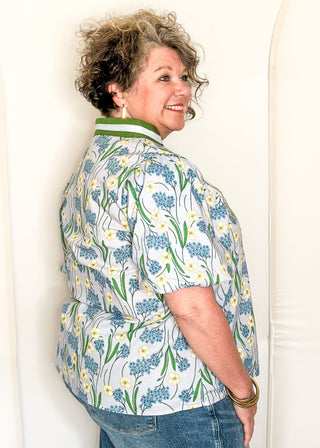 Spring floral top with short sleeves, easy silhouette, and colorful blue and green pattern.