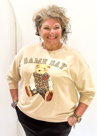 Tan long sleeve pullover with "GAME DAY" in arched bold lettering above Benny the Bear in his leopard letterman jacket.  