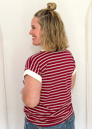 wide striped top with cuffed sleeves, and white banded rounded neckline.
