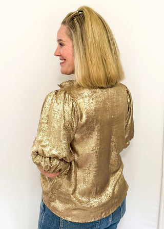 Shimmer gold lightweight button up blouse with collared neckline and ruched sleeves.