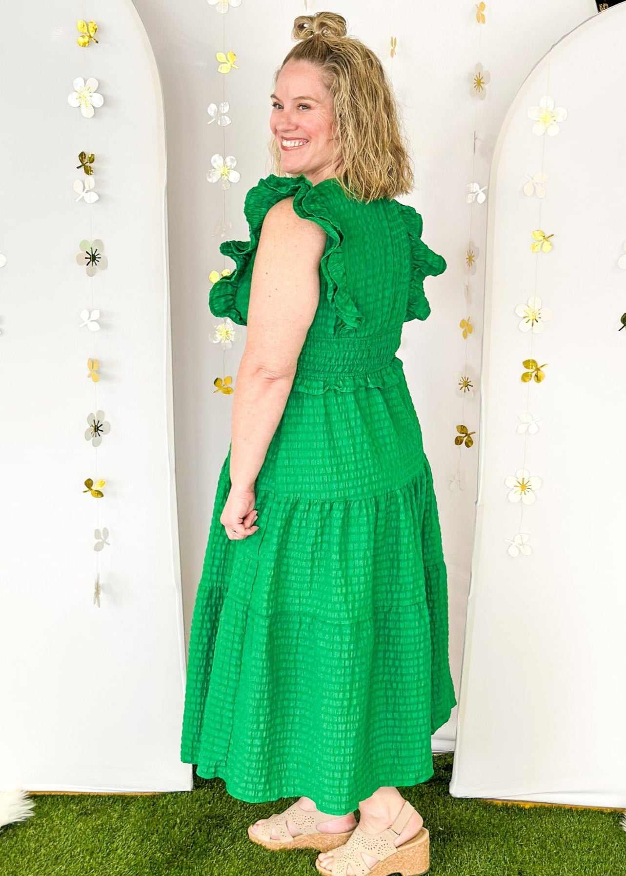 Flutter sleeve, V-neck tiered dress-ruffle detail at waist. Solid color in Kelly Green with seersucker like texture. 