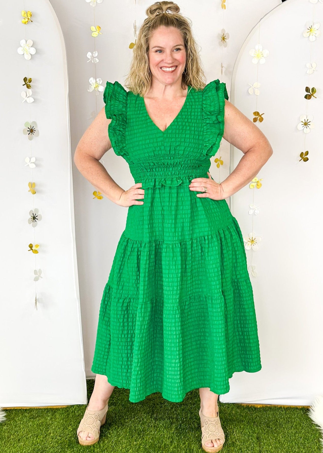 Flutter sleeve, V-neck tiered dress-ruffle detail at waist. Solid color in Kelly Green with seersucker like texture. 