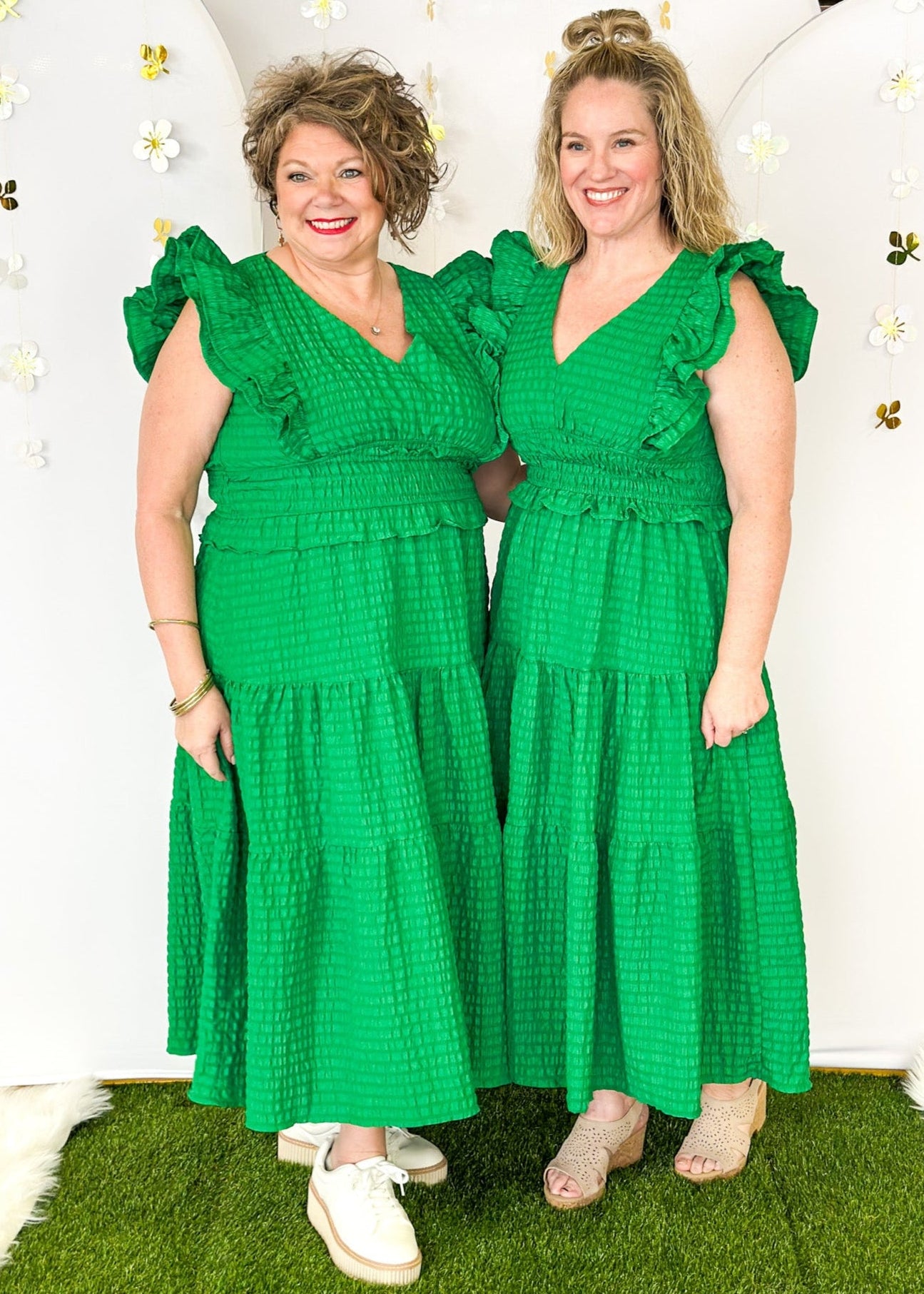 Flutter sleeve, V-neck tiered dress-ruffle detail at waist. Solid color in Kelly Green with seersucker like texture. 