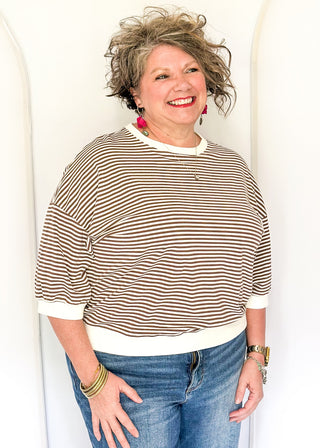 Striped knit dolman top with crew neckline and ribbed trim in brown.