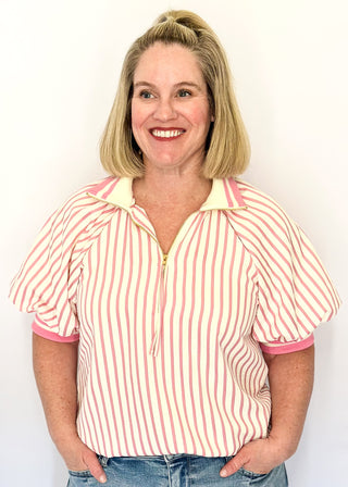 Women’s pink striped short sleeve 1/4 zip top with lightweight fabric, stripe elastic sleeve and collar detail.