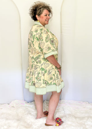 Women's floral dress with sage botanical print, striped seersucker trim, and buttons.