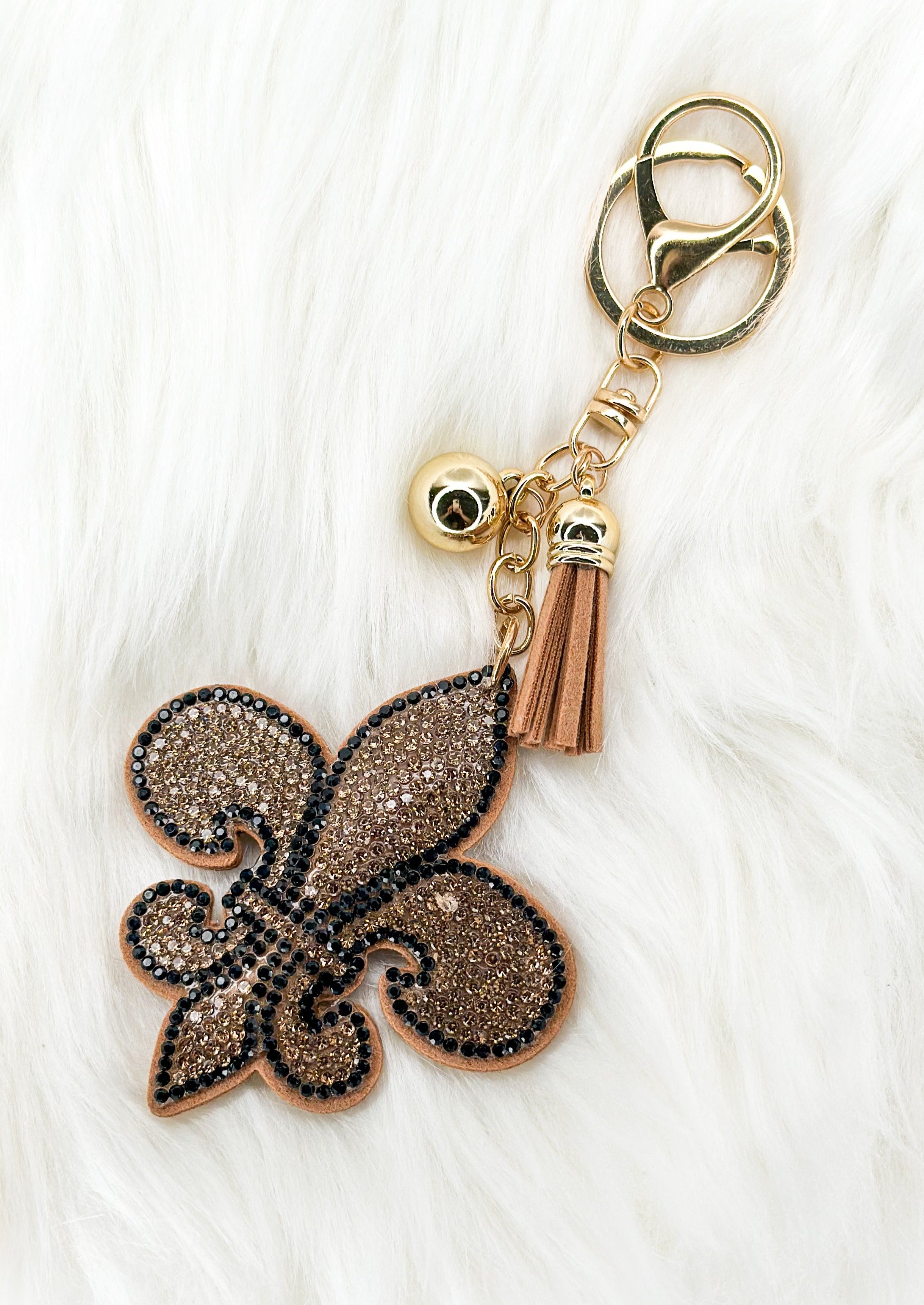 Fleur de lis sparkly keychain with gold tassel and hardware.