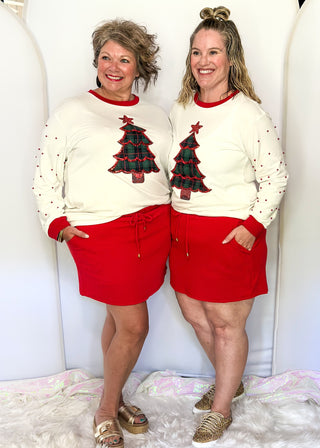 Bright red ribbed skort with drawstring waist and side pockets.