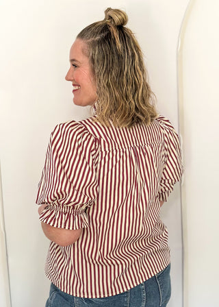 woman standing to show back of striped top 
