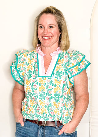 Floral print top with decorative neckline and short ruffle sleeves