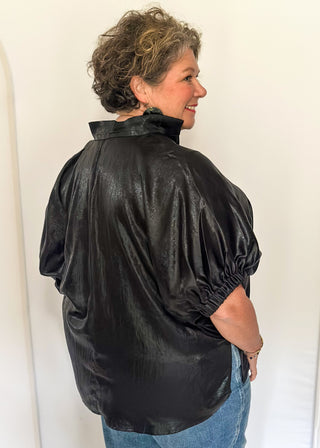 Shimmer black V-neck blouse with relaxed elastic short sleeves and a split hem at waist. 