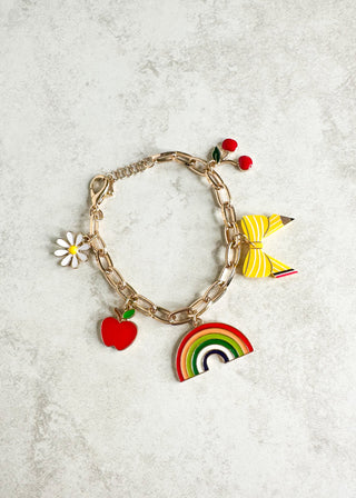 Bracelet with colorful charms including a rainbow, apple, and butterfly on a light gray background