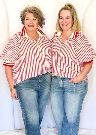 Women’s red striped short sleeve 1/4 zip top with lightweight fabric, stripe elastic sleeve and collar detail.