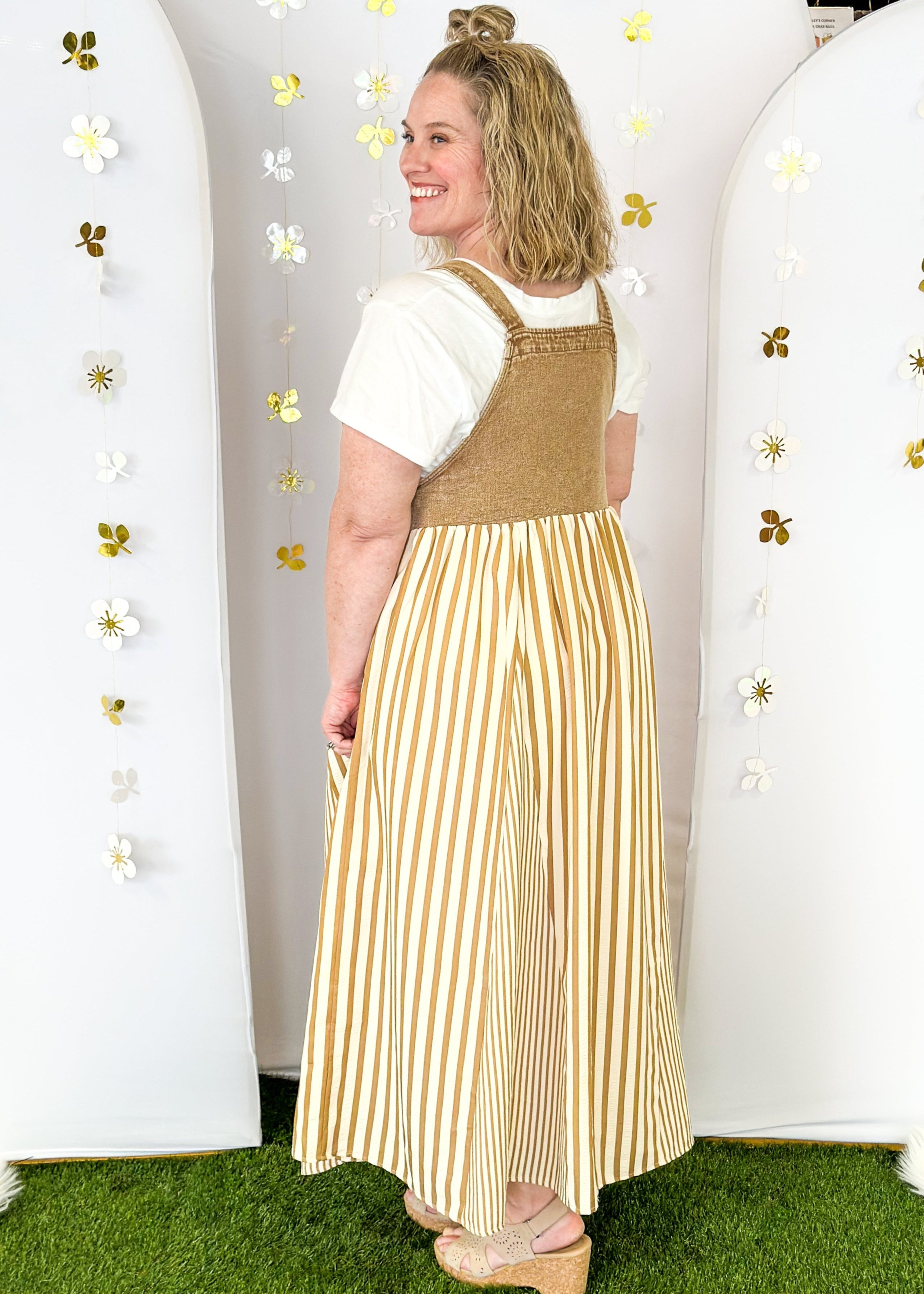 Maxi dress with pockets. brown vertical stripes on the bottom and brown denim overall top. Large front pocket and two buttons on either strap to adjust length.