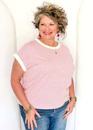 Pink and white stripe short sleeve top with white contrast banding on the collar and sleeves. 