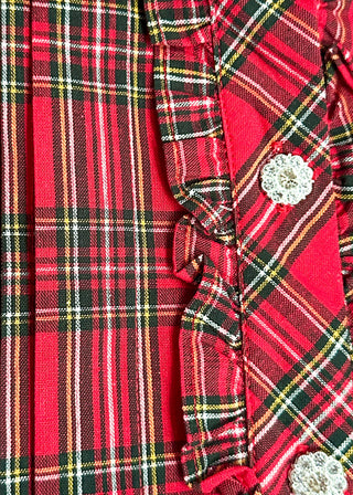 close up of red plaid fabric and rhinestone buttons