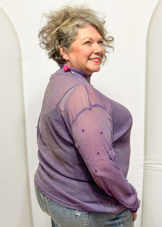 Long sleeve mock neck top with pearl accented sleeves in purple with gold metallic threads.