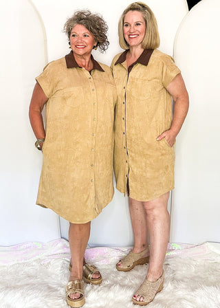 two women modeling a twill suede button up dress with brown corduroy collar and pockets.
