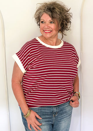 wide striped top with cuffed sleeves, and white banded rounded neckline.