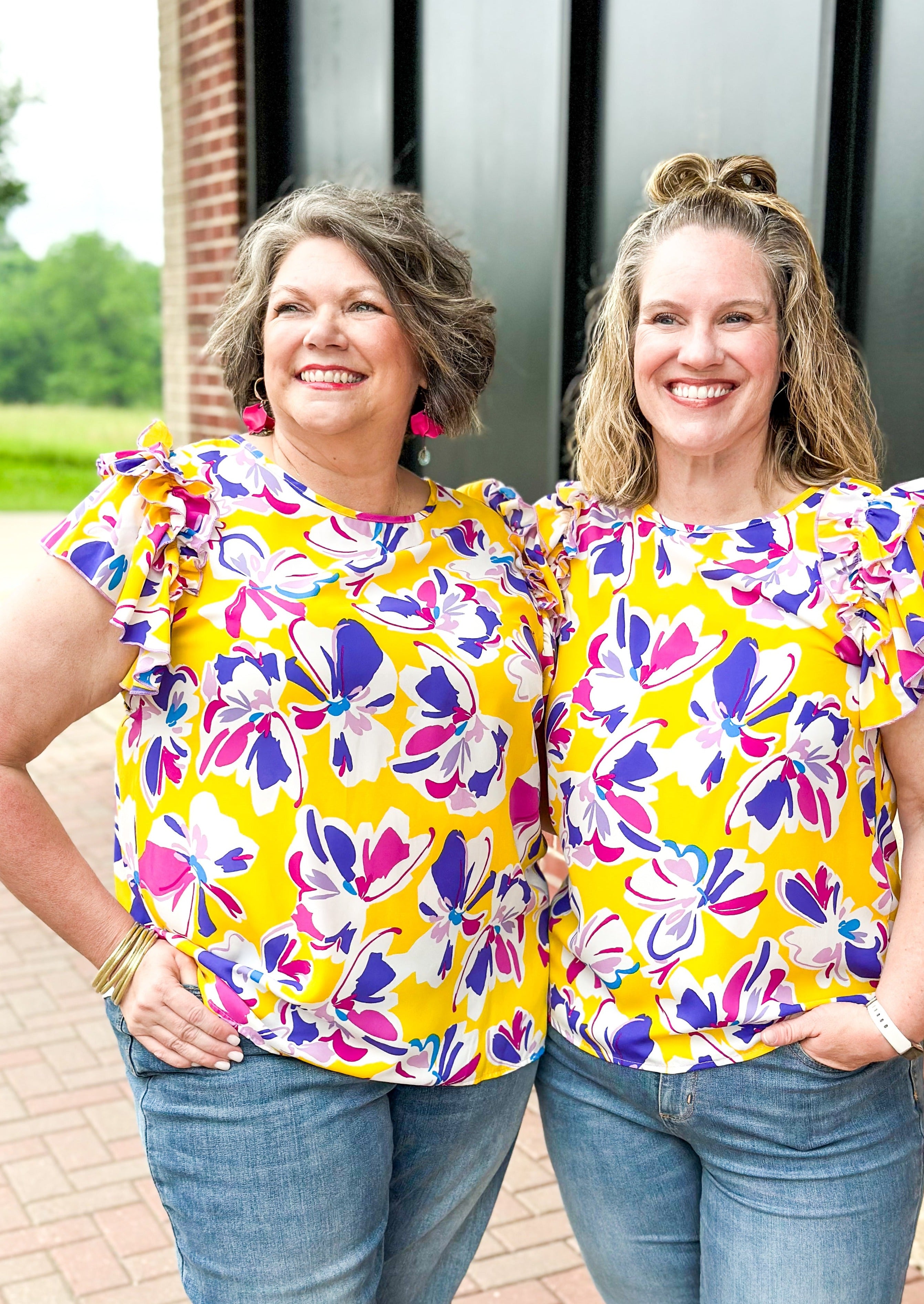 Purple and pink flowers on a yellow top with double ruffle sleeve